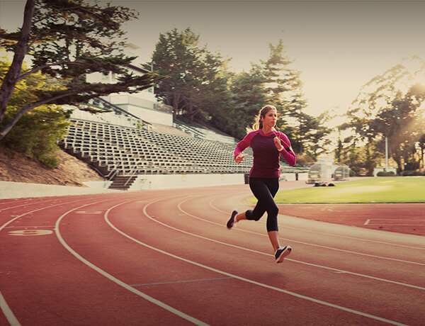 Woman running on a track