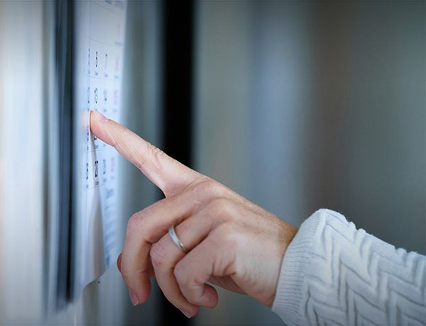 Finger pointing at wall calendar