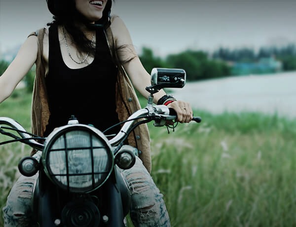 Woman sits on motorcycle