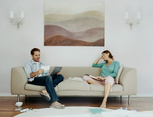 Couple sits on white couch
