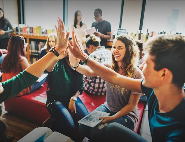 College students giving a group high five